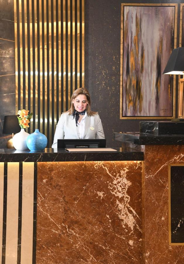Tolip Gardens Hotel Cairo Exterior photo A hotel receptionist at the front desk
